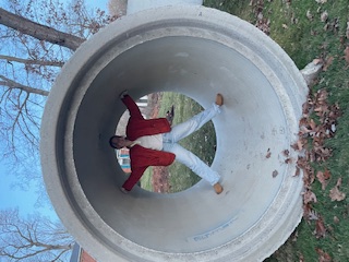 Concrete storm pipe staged for installation in residential area.